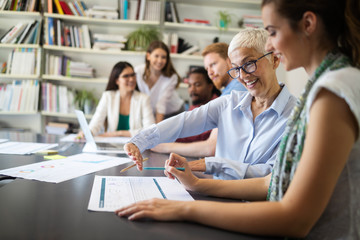Group of business people collaborating on project in office