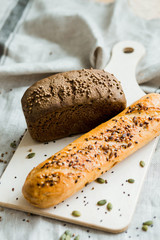 Freshly baked bread on dark grey fabric with seed