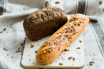 Freshly baked bread on dark grey fabric with seed