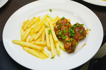 Chicken legs with french fries potatoes