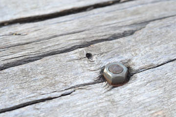  Bolt on the background of an old wooden table