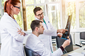 Fototapeta premium Doctors team having medical council in hospital. Discussing medical issues.