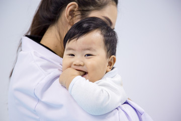 Obraz premium Doctor happy to little boy.medicine, healtcare, pediatry and people concept - happy doctor or pediatrician holding baby.