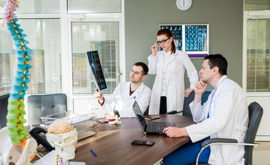 Doctors team having medical council in hospital. Discussing medical issues. Spine fixation systems