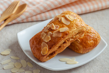 Almond danish pastry on white plate