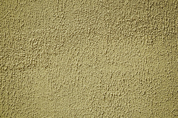 Wall plaster covered by yellow rough paint