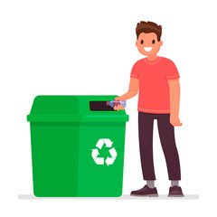 Man throws a plastic bottle into the trash can. The concept of caring for the environment and sorting garbage