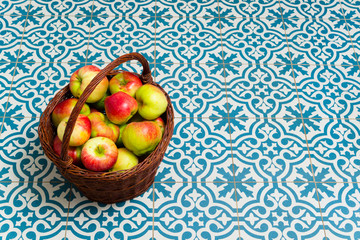 basket of apple on kitchen tile floor