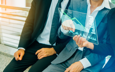 Close up of businessman and businesswoman presenting digital charts.Business growth, progress or success concept. Businessman is showing a growing virtual hologram stock
