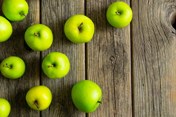 green apples on old wooden background