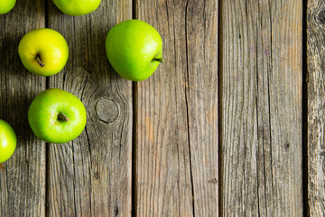 green apples on old wooden background