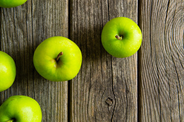 green apples on old wooden background