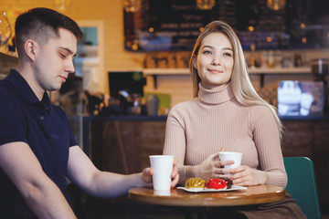 Two cute young boy and girl in a cafe.