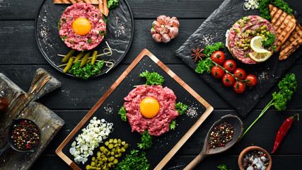 French traditional cuisine. Tartar with egg, avocado, onion and pickled cucumber. Top view. Free space for your text.