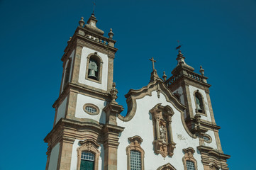 Fototapeta na wymiar Baroque bell towers from church with whitewashed wall