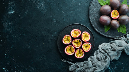 Passion fruits in a plate. Tropical Fruits. Top view. Free space for text.