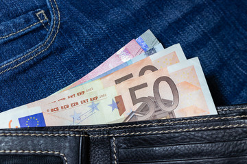 Euro money, Euro Banknote inside black leather wallet on Jean Background.