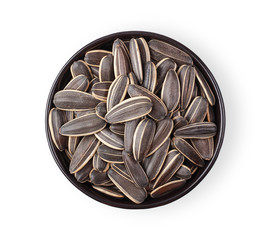 Sunflower seeds in a black cup isolate on a white background. Top view