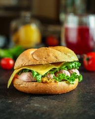 burger with sausages, cf, lettuce, tomato sauce (snack sandwich, kaiser bun). top food background. copy space