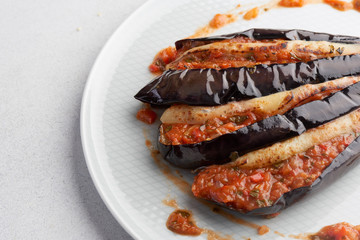 baked eggplant with filling on a white plate
