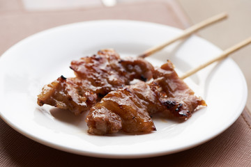 A plate of grilled pork on the table