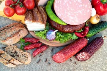Meat food and vegetables are lying on the table.