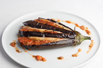 baked eggplant with filling on a white plate