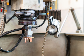 close up copper electrode during setup on automatic electrical discharge machine (edm) or spark machining
