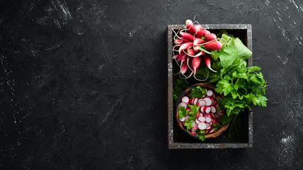 Red radish in a wooden box. Fresh vegetables. Top view.