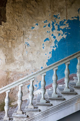 Old staircase in interior of an abandoned and ruined building