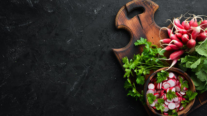 Sliced radishes on a Wooden Table. Fresh vegetables. Top view. Free space for text.