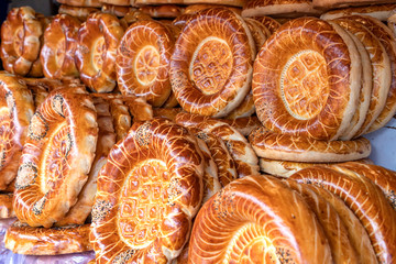Oriental flat cakes decorated with patterns and seeds close up