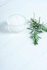 bath salts in glass pot on white wooden, with lavender leaves