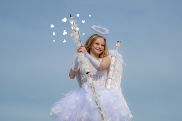 Child with angelic character. Lovely and cute youth. Girl angel with halo in white angel dress....
