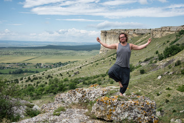 Yoga practice. A man is resting in the mountains.