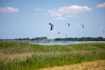 Kite surfers race across the sea