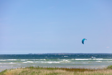 Kite surfers race across the sea