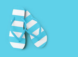 Top view of summer beach light blue flip flop on azure background sea holiday vacation and travel concept