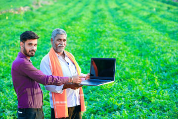 indian agronomist with farmer at field