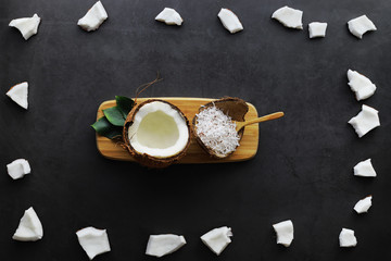 Coconut on a dark stone table. Coconut oil.