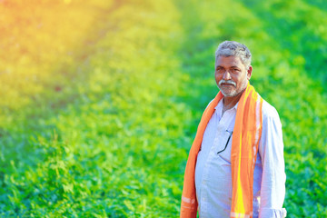 Young indian farmer at field
