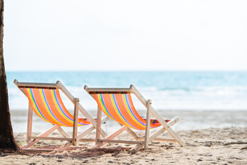Fototapeta na wymiar Chair beach for relaxation at the beautiful white sandy beach