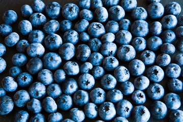 gathering of blueberries on black slate