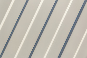 Background. The surface of the white profiled sheet. Roofing material and wall decoration