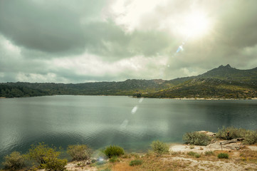 Fototapeta na wymiar Fresh water at the Rossim Lake in a rocky landscape