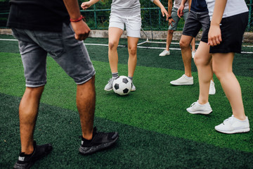 Football players running for the ball, kick the ball.