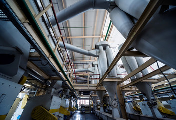 Interior of modern natural oil factory. The piping, pumps and motors