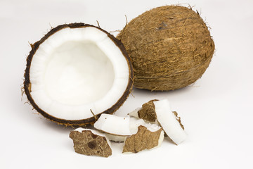 fresh coconut pieces with coconut half and whole coconut