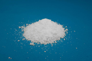a mountain of white powder on a blue background