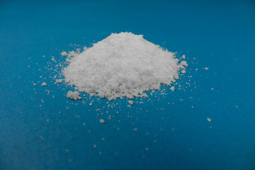 a mountain of white powder on a blue background